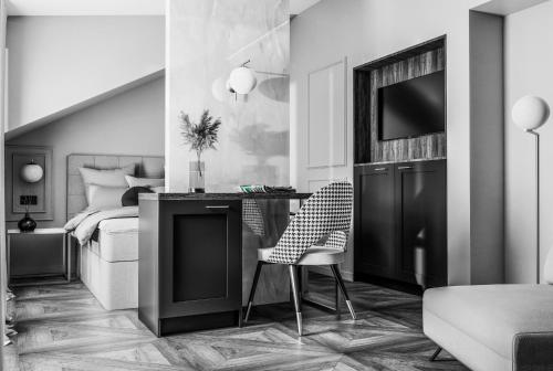 a bedroom with a bed and a desk with a chair at boutique Villa Dorma in Dubrovnik