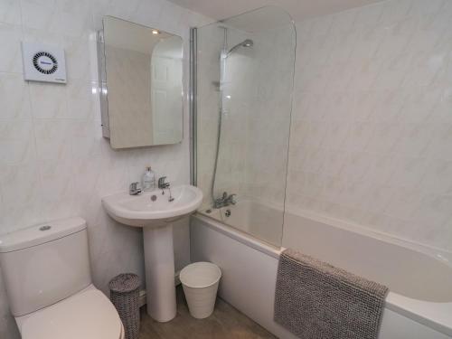 a bathroom with a sink and a toilet and a shower at 1 Bishopgate Court in Goole