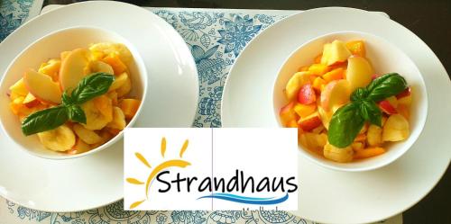 two bowls of fruit on plates on a table at Strandhaus Condotel in Moalboal