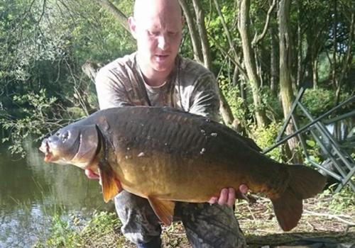 a man holding a large fish in his hand at 7 Lakes Breaks at 7 Lakes Country Park-WF73 in Crowle