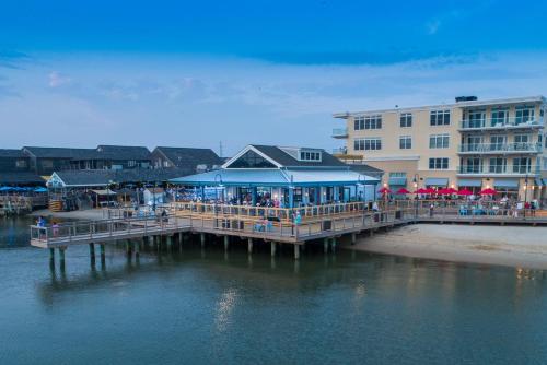 a pier with a seafood restaurant on the water at Hyatt Place Dewey Beach in Dewey Beach