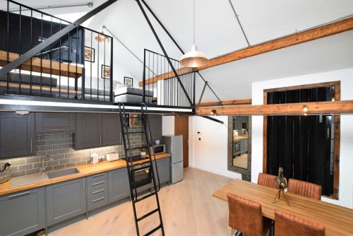 a loft kitchen with a ladder and a table at Nap Bristol City Centre in Bristol