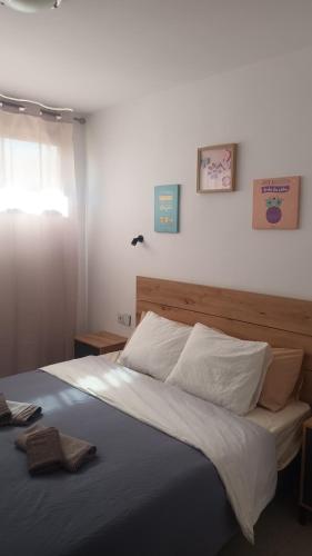 a bedroom with a large bed with white sheets at Apartamento SMILE Complex Amaya Fuerteventura in Costa de Antigua