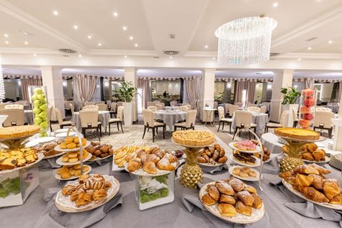 a buffet of food on a table in a restaurant at Hotel Sporting in Rimini