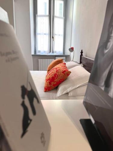 a bed with two pillows on it in a room at XX Settembre Studio Apartment in Parma