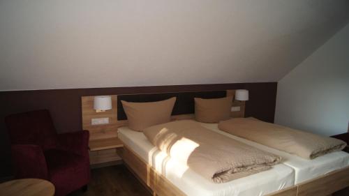 a bedroom with a large bed with lights on it at Gästehaus Winzerhof am Schlierbach in Weiler bei Weinsberg