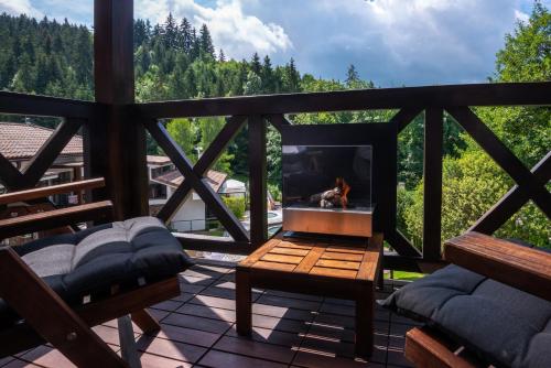a balcony with a fireplace and a table and chairs at Villa Helia in Dolný Kubín