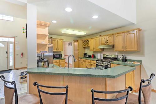 a large kitchen with wooden cabinets and a counter top at Game Room and Fire Pit Poconos Family Getaway in Tobyhanna