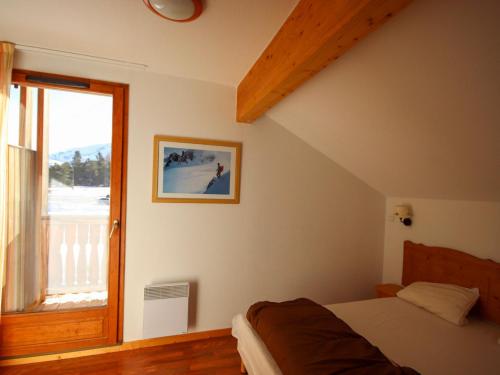 a bedroom with a bed and a large window at Chalet Le Dévoluy, 3 pièces, 6 personnes - FR-1-504-502 in Superdevoluy