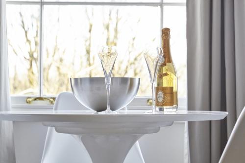a white table with a bottle of champagne and a bowl at nap Bristol Clifton in Bristol