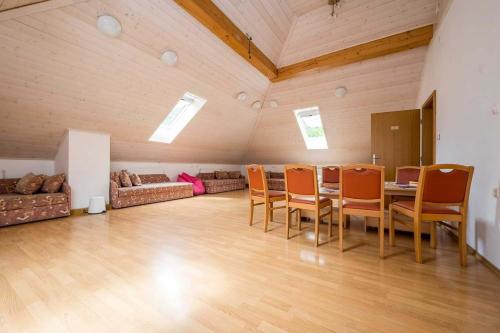 a large room with a table and chairs and a couch at Hostel Kronotop in Triglav National Park in Log pod Mangartom