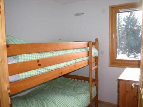 a bunk bed in a room with a window at Appartement Samoëns, 4 pièces, 6 personnes - FR-1-629-87 in Samoëns