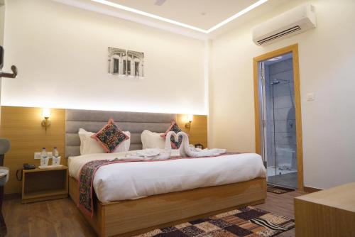 a bedroom with a large bed in a room at Hotel Luxurio by Shree Hari Hotels in Amritsar