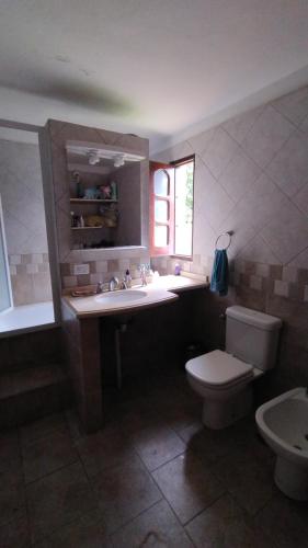 a bathroom with a sink and a toilet at Casafamiliar in Villa San Nicolás