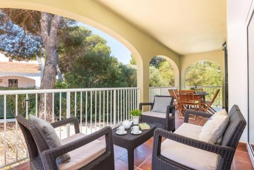a porch with wicker chairs and a table at SolParc 589 in Son Parc