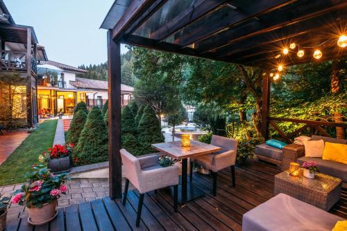 a patio with a table and chairs on a deck at Villa Helia in Dolný Kubín