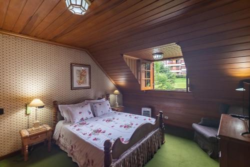 een slaapkamer met een bed in een kamer met een raam bij Pousada C Turismo in Campos do Jordão