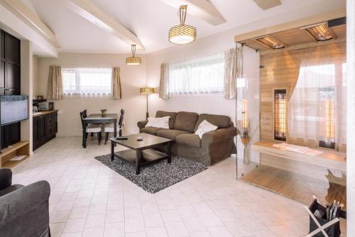 a living room with a couch and a table at Villa Helia in Dolný Kubín