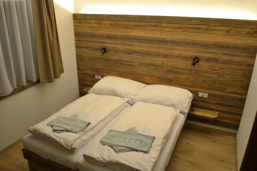 1 cama con 2 almohadas en una habitación en Tri kopy*** - penzión, reštaurácia a pizza, en Smrečany