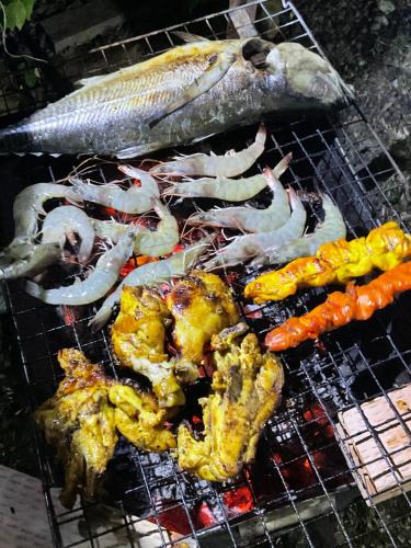una parrilla con pescado y verduras. en Mada Lanta Mai Keaw, en Ko Lanta