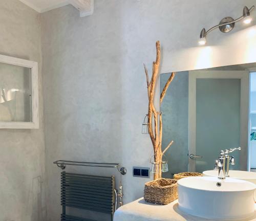 a bathroom with a sink and a mirror at Casa Mariposa in Es Pujols