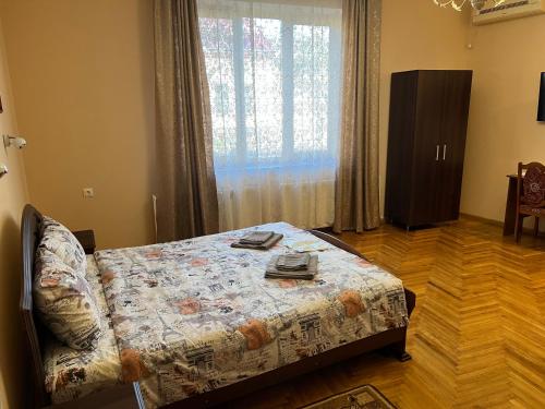 a bedroom with a bed and a large window at Villa Magda in Berehove