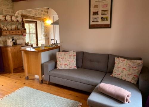 a living room with a couch and a kitchen at Coutillard in Parisot-Tarn-et-Garonne