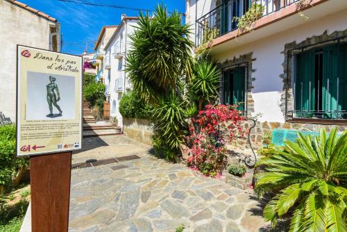 a sign in front of a building with plants at Villa Camille Hotel & Spa in Banyuls-sur-Mer