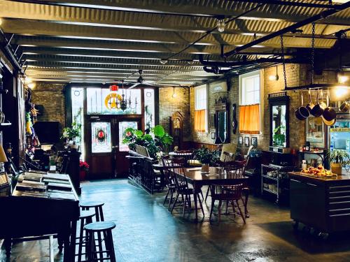 a restaurant with tables and chairs in a room at Inn at the Old Jail, WALK TO JAZZ FEST! in New Orleans