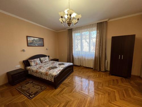 a bedroom with a bed and a large window at Villa Magda in Berehove