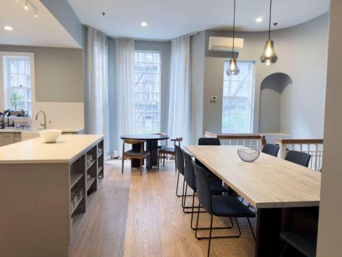 a kitchen and dining room with a table and chairs at Outsite Chelsea in New York