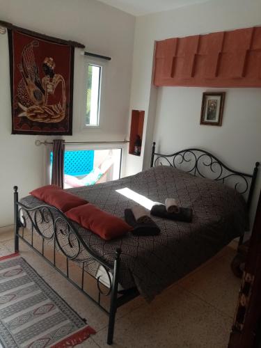 a bedroom with a black bed with a red blanket at Janna d'Ifni in Sidi Ifni