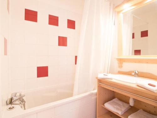 ein weißes Badezimmer mit einer Badewanne, einem Waschbecken und einem Badetubermott in der Unterkunft Appartement Puy-Saint-Vincent, 3 pièces, 6 personnes - FR-1-504-106 in Puy-Saint-Vincent
