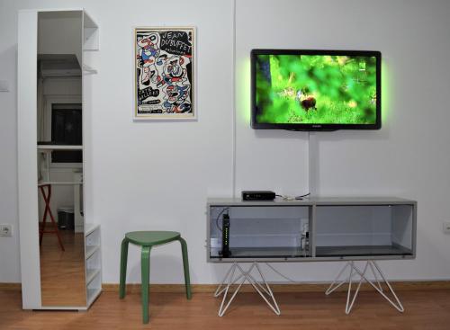 a living room with a tv on a white wall at Art nature, Belgrade, Medak in Voždovac