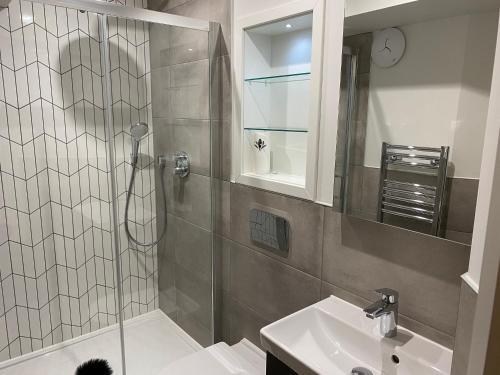 a bathroom with a shower and a sink at Nice Apartment Close to Ilford Station , NETFLIX AND WI-FI FREE in Ilford
