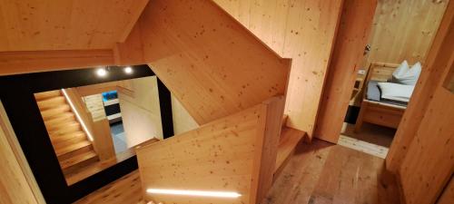 an overhead view of a wooden cabin with a bedroom at Chalet Ablon in Saalbach-Hinterglemm