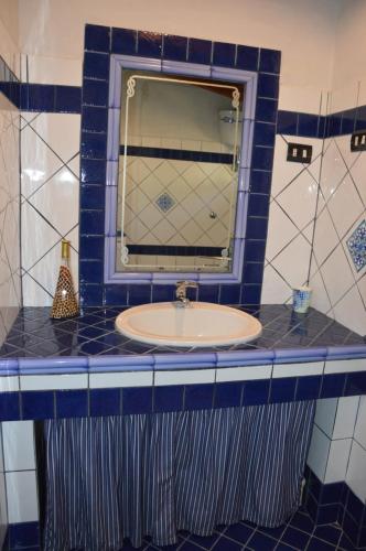 a bathroom with a sink and a mirror at Giardino degli Ulivi in Gonnesa