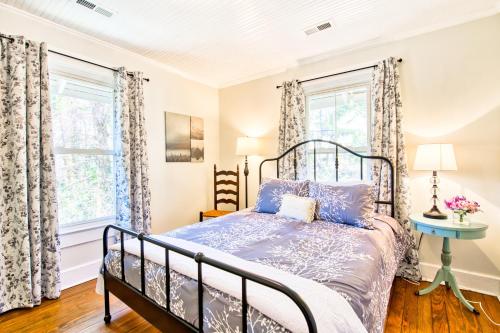 een slaapkamer met een bed en 2 ramen bij Cannon Cottage A in Montreat
