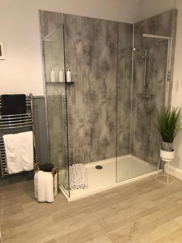 a shower with a glass enclosure in a bathroom at The Skreen in Builth Wells
