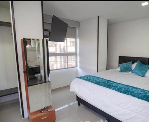 Uma cama ou camas num quarto em Elite Home Apartamentos