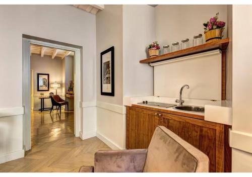 a kitchen with a sink and a counter at Suites Giulia in Rome