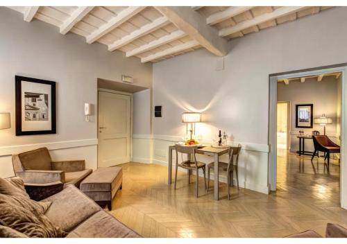 a living room with a couch and a table at Suites Giulia in Rome