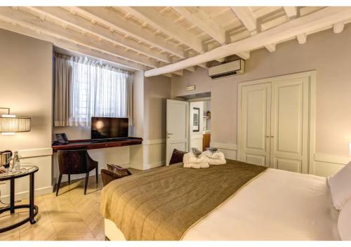a bedroom with a large bed with two stuffed animals on it at Suites Giulia in Rome