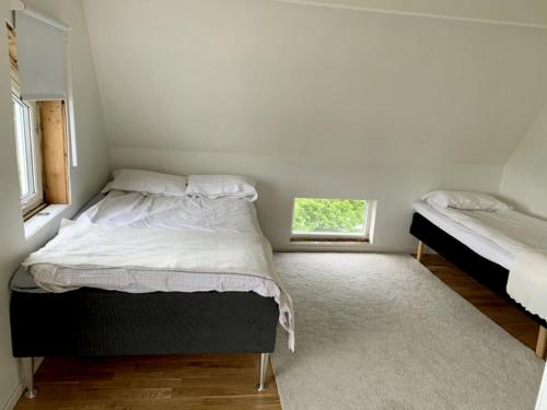 a small bedroom with two beds and a window at Modern villa near Gothenburg in Gothenburg