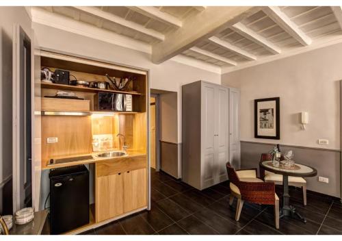 a kitchen and dining room with a table and a counter at Suites Giulia in Rome