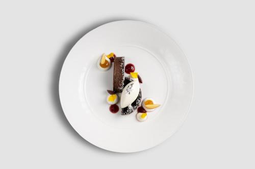 a plate with a piece of chocolate dessert on it at Baglioni Resort Maldives - Luxury All Inclusive in Dhaalu Atoll