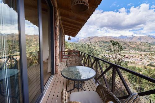 a balcony with a table and chairs and a view at Wayarumi Skyhotel in Carhuaz