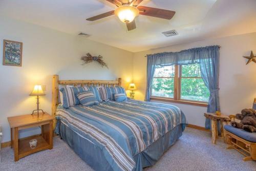 a bedroom with a bed and a ceiling fan at The Hive Trailside At Pleasant Mnt Ski Area in Bridgton