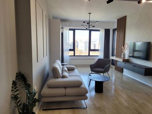 a living room with a couch and a chair at BS Apartment in Skopje