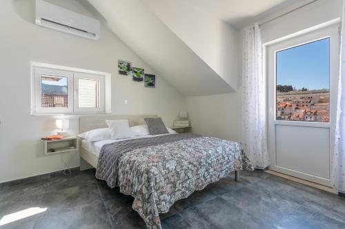 a bedroom with a bed and a large window at Sea view from the center of Hvar in Hvar